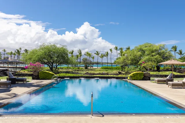 a view of a swimming pool with lounge chair