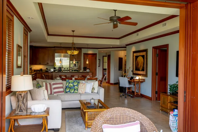 a living room with furniture and a chandelier