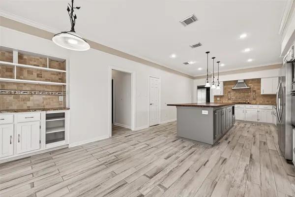 a large kitchen with stainless steel appliances kitchen island a large island in the center