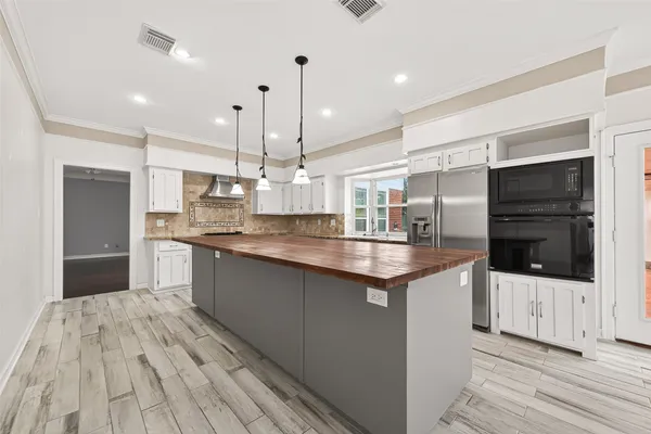 a kitchen with stainless steel appliances granite countertop a sink and cabinets