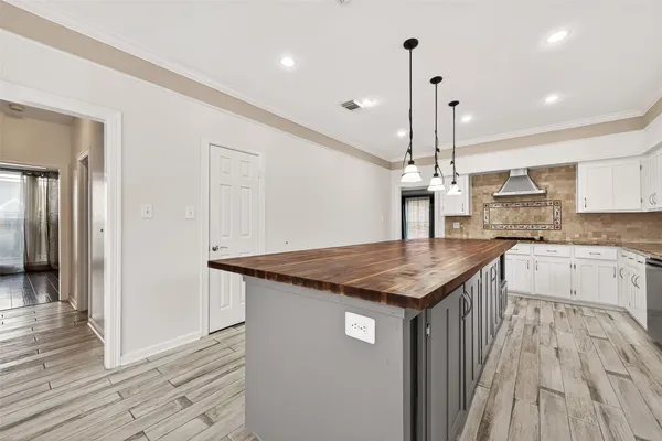 a kitchen with stainless steel appliances granite countertop a sink a counter space and wooden floor