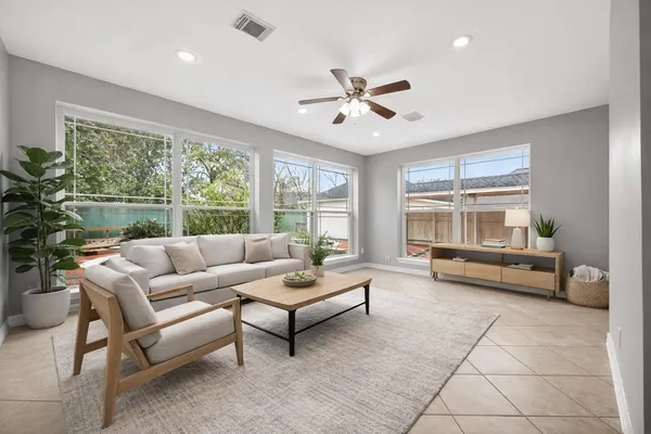 a living room with furniture and a large window