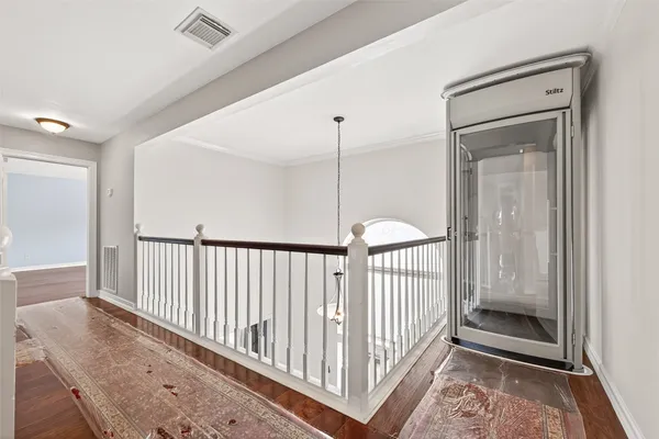 a view of a hallway with a door and stairs