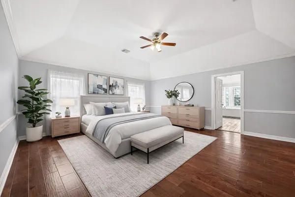 a bedroom with a bed mirror and window