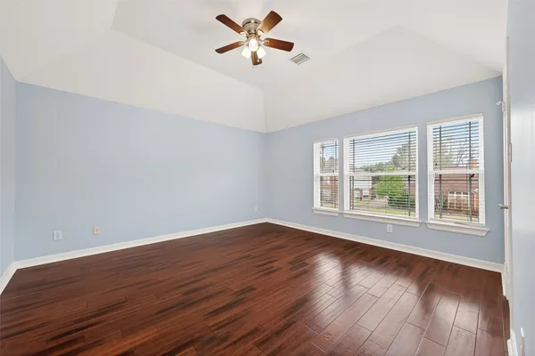wooden floor in an empty room with a window