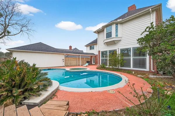 a view of a house with swimming pool and sitting area