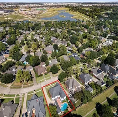 an aerial view of residential houses with outdoor space