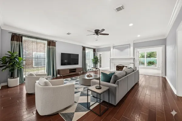 a living room with fireplace furniture and a flat screen tv