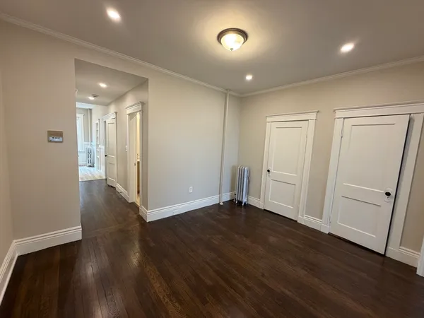 a view of a hallway with wooden floor