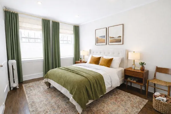 a bedroom with a bed a mirror and a window