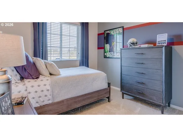 a bedroom with a bed and a dresser