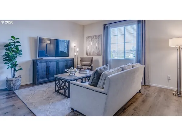 a living room with furniture and a potted plant