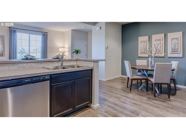 a open kitchen with granite countertop a sink cabinets and wooden floor