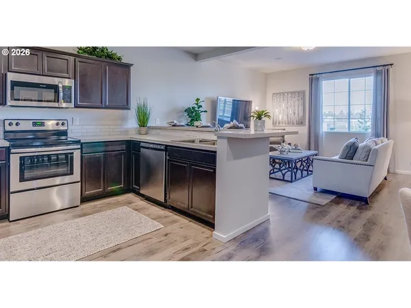 a kitchen with kitchen island granite countertop a stove top oven and sink