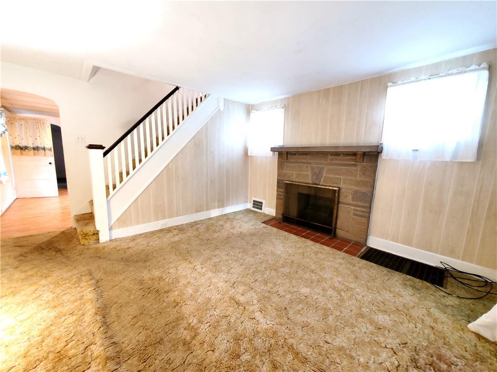 422 Thompson Run Road Pittsburgh, PA 15237 - Photo 5 of 10 a view of an empty room with wooden floor fireplace and a window