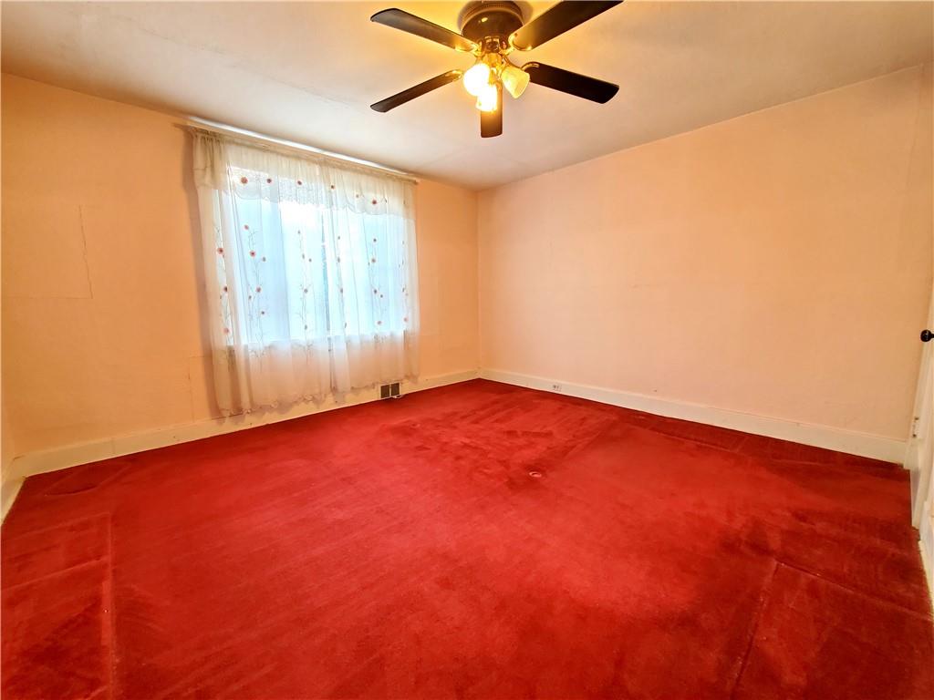422 Thompson Run Road Pittsburgh, PA 15237 - Photo 8 of 10 an empty room with a window and a fan
