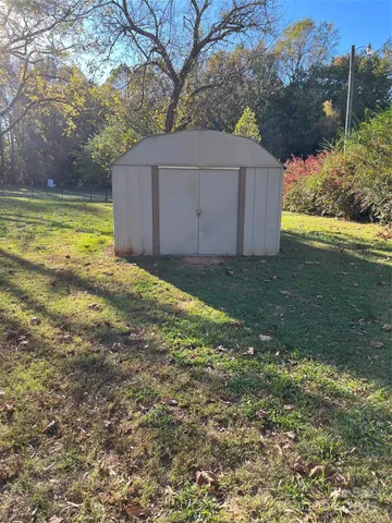 a view of a backyard with large trees