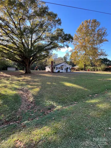 a view of a yard with a house in the background