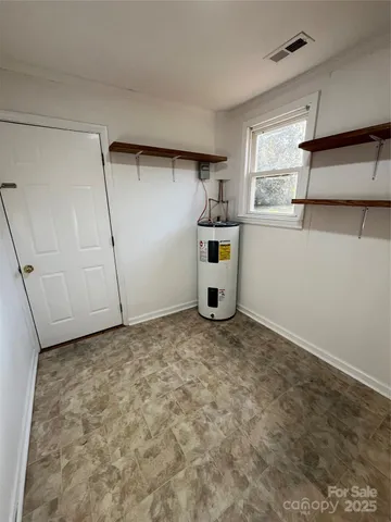 a view of a kitchen with a sink and a refrigerator