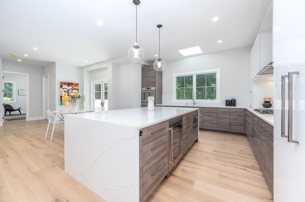 142 Bellingham Road Chestnut Hill, MA 02467 - Photo 11 of 37 a large kitchen with a large counter top a sink a counter space and stainless steel appliances