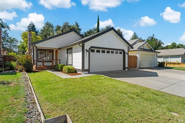 a view of a house with backyard and garden