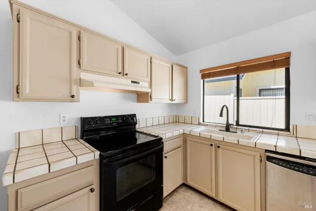 a kitchen with a sink stove and cabinets