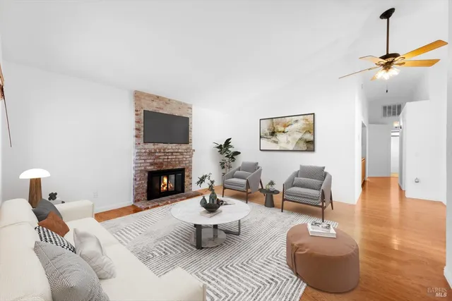 a living room with furniture a fireplace and a flat screen tv