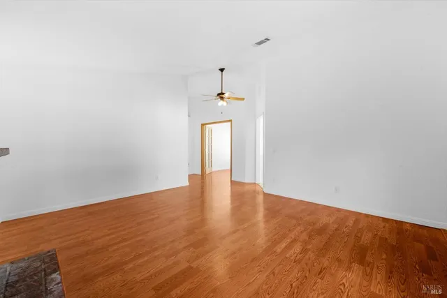 a view of an empty room and wooden floor