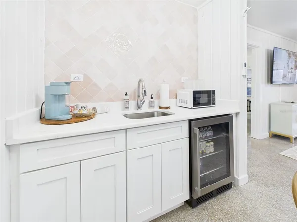 a kitchen with cabinets a sink and appliances