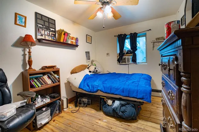 a bedroom with furniture and a book shelf