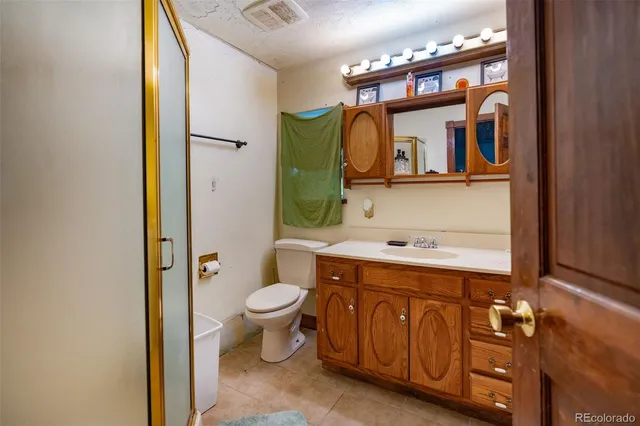 a bathroom with a sink a toilet and mirror