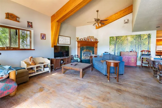 a bedroom with furniture a lamp and a large window