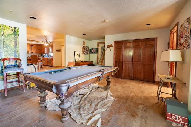 a room with pool table and windows