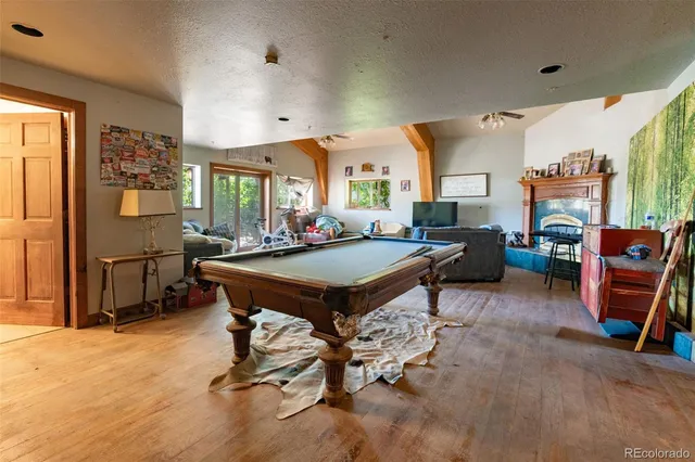 a living room with furniture a rug and a flat screen tv