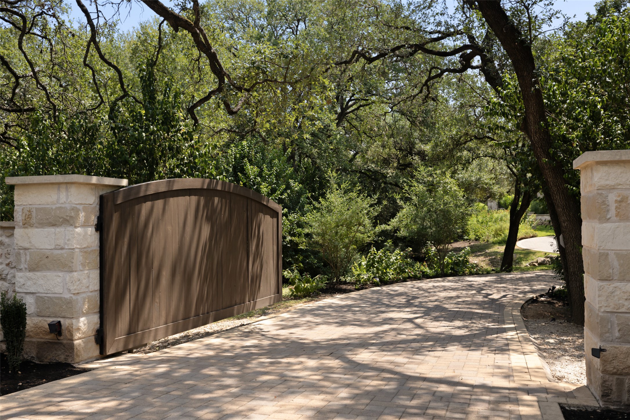 3667 Stoneridge Road Austin, TX 78746 - Photo 4 of 40 A private gate frames the entrance, setting an immediate tone of privacy and intention that carries throughout the estate.