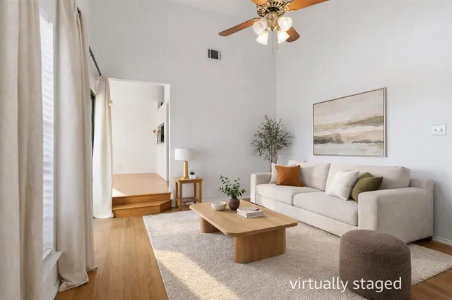 a view of a livingroom with wooden floor and windows