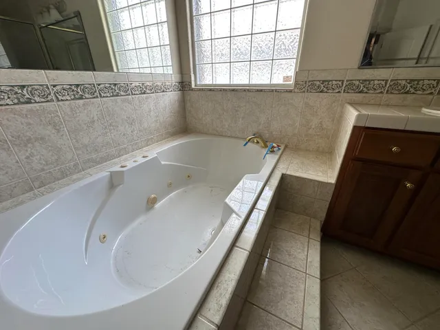 a view of a hallway with wooden cabinets
