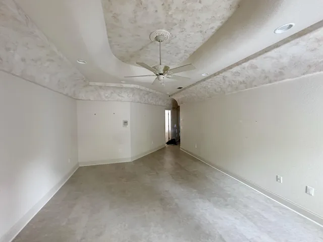 a view of a swimming pool with a patio and a yard