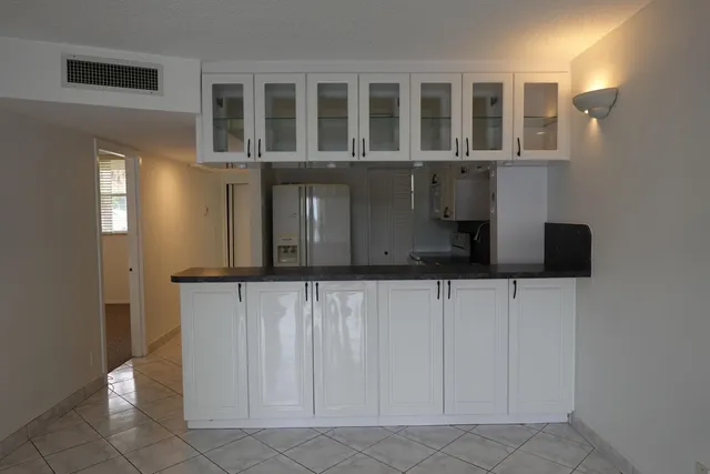 a kitchen with a refrigerator and cabinets