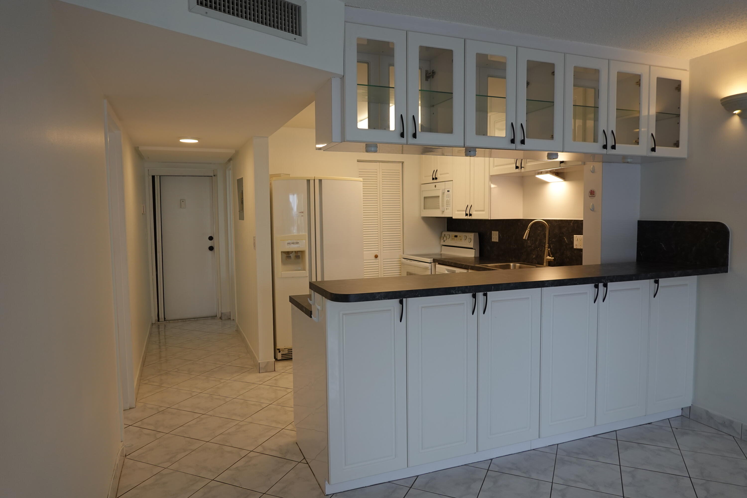 5321 Northeast 24th Terrace, Unit 112A Fort Lauderdale, FL 33308 - Photo 4 of 21 a kitchen with stainless steel appliances granite countertop a refrigerator and a stove top oven