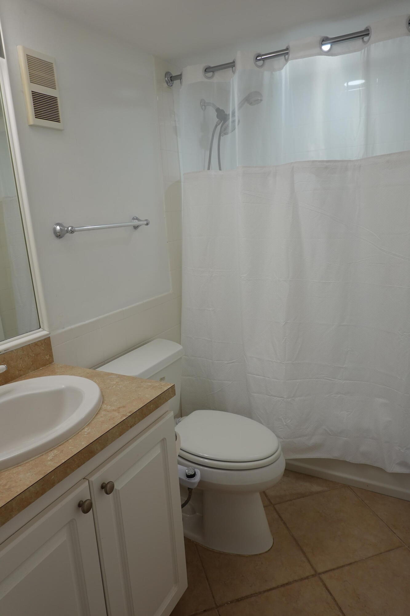 5321 Northeast 24th Terrace, Unit 112A Fort Lauderdale, FL 33308 - Photo 10 of 21 a bathroom with a granite countertop sink toilet and a mirror