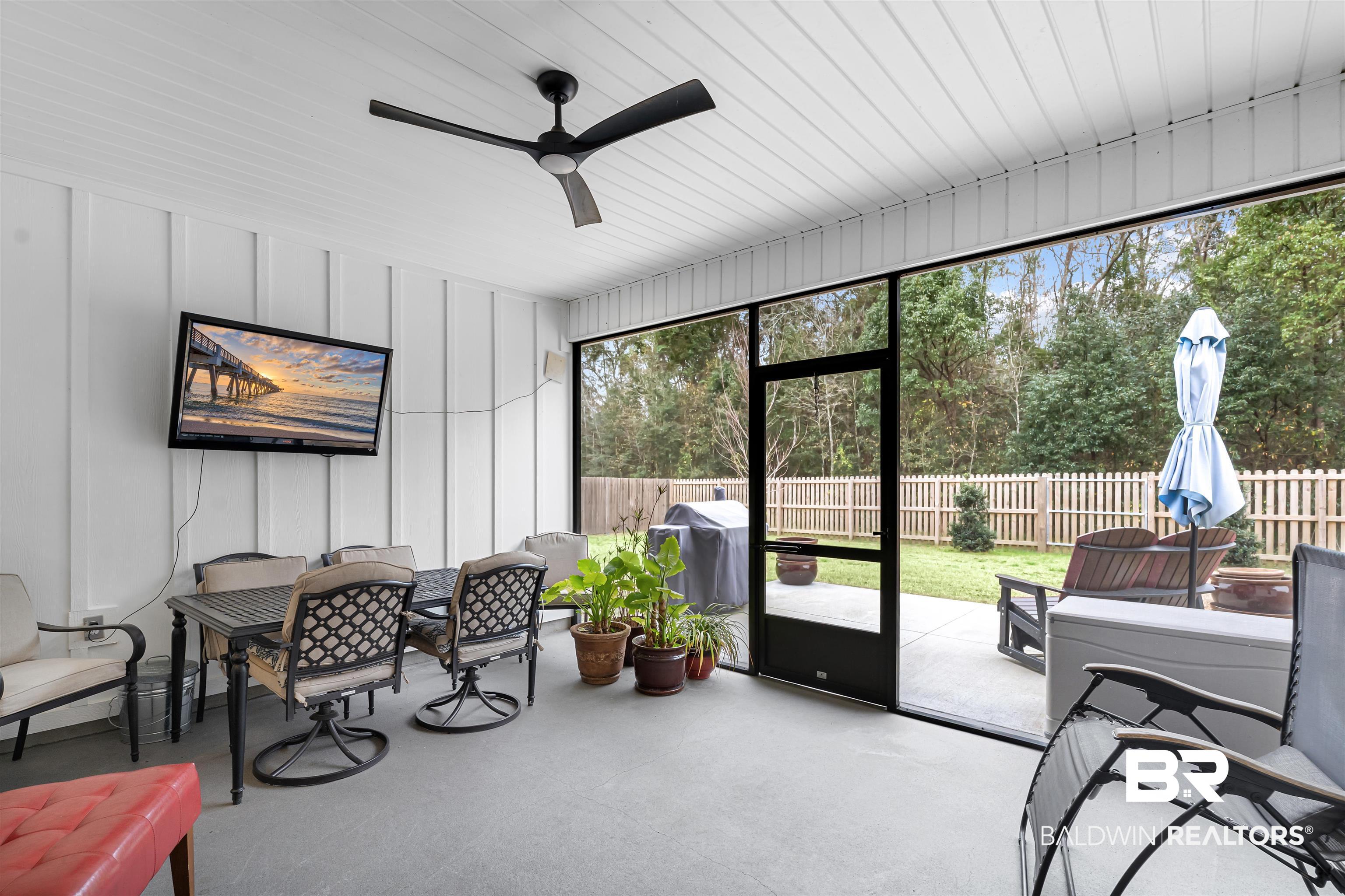 697 Calibre Street Fairhope, AL 36532 - Photo 16 of 18 Sunroom with ceiling fan and outdoor dining space