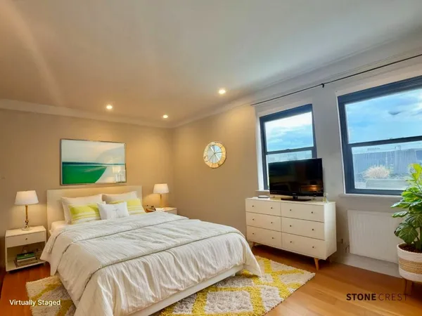 a bedroom with a bed and a flat screen tv