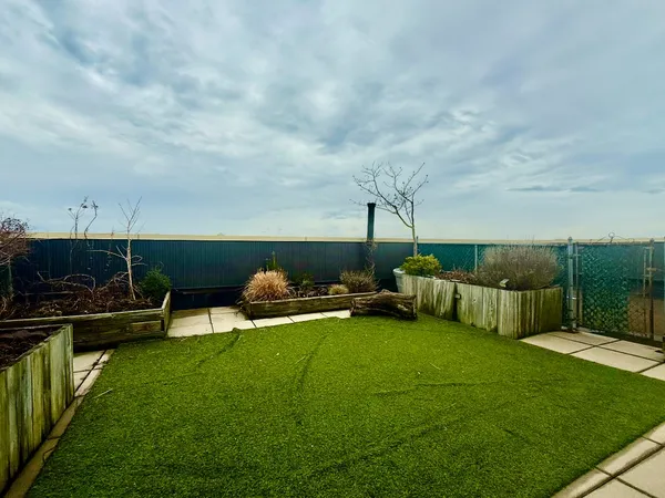 a view of a garden with lawn chairs