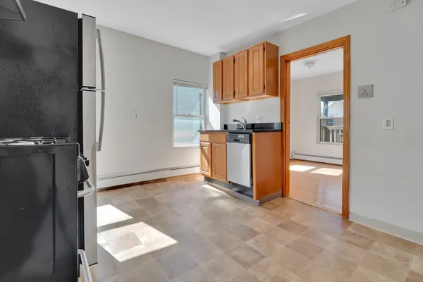 a kitchen with granite countertop a refrigerator and a stove top oven