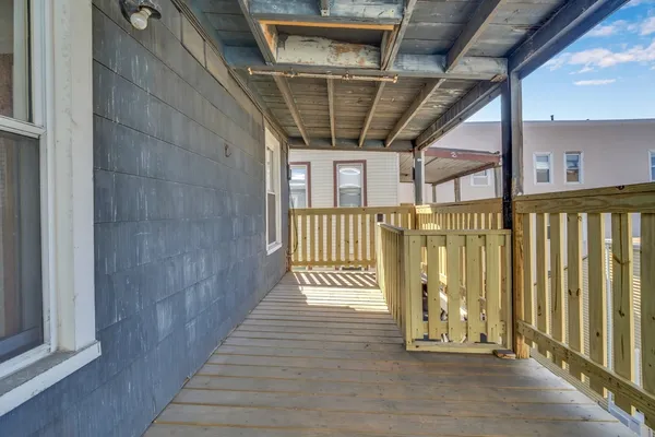 a view of a porch with wooden floor and stairs
