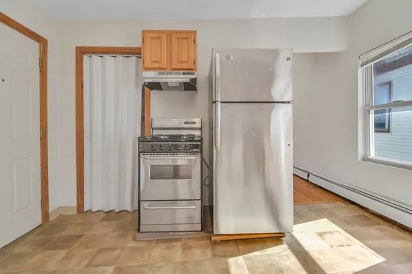 a kitchen with stainless steel appliances granite countertop a refrigerator and a stove