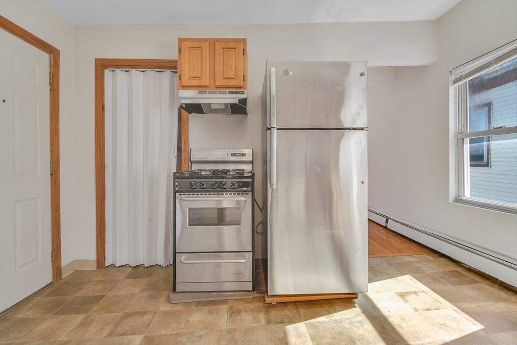 11 Carpenter Street, Unit 3 Boston, MA 02127 - Photo 5 of 22 a kitchen with stainless steel appliances granite countertop a refrigerator and a stove