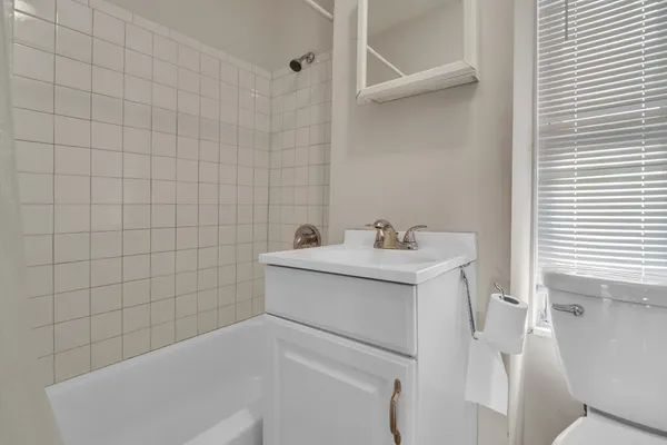 a bathroom with a sink and mirror with toilet