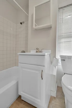 a bathroom with a sink a toilet and bathtub